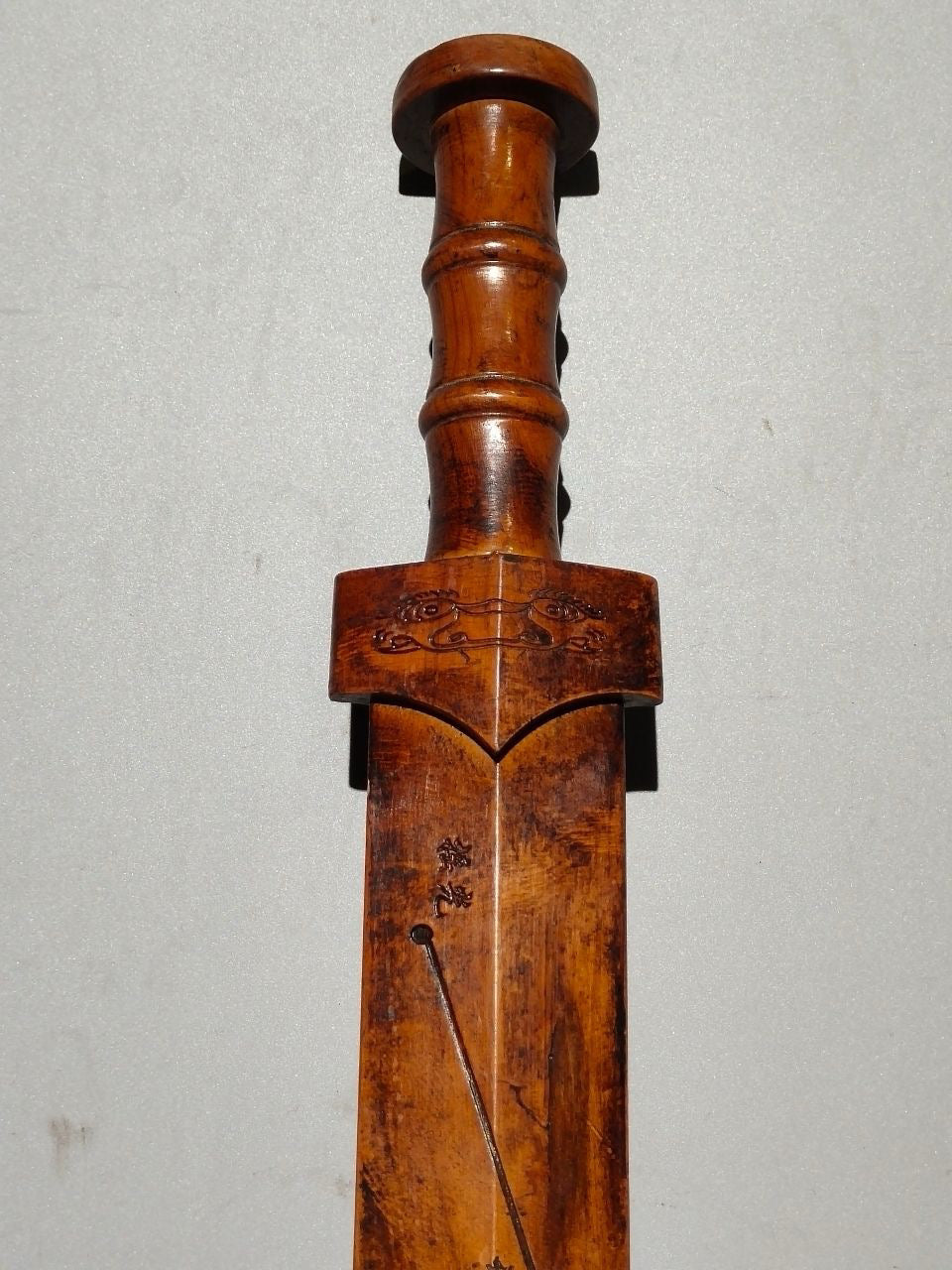 A solid wood carved sword