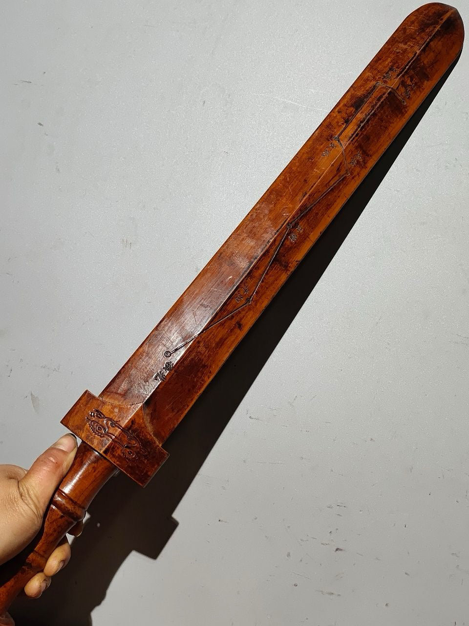 A solid wood carved sword