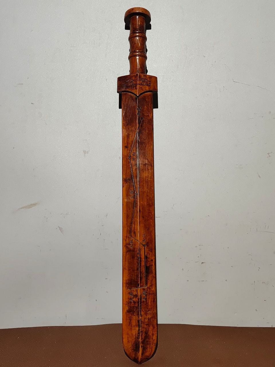 A solid wood carved sword