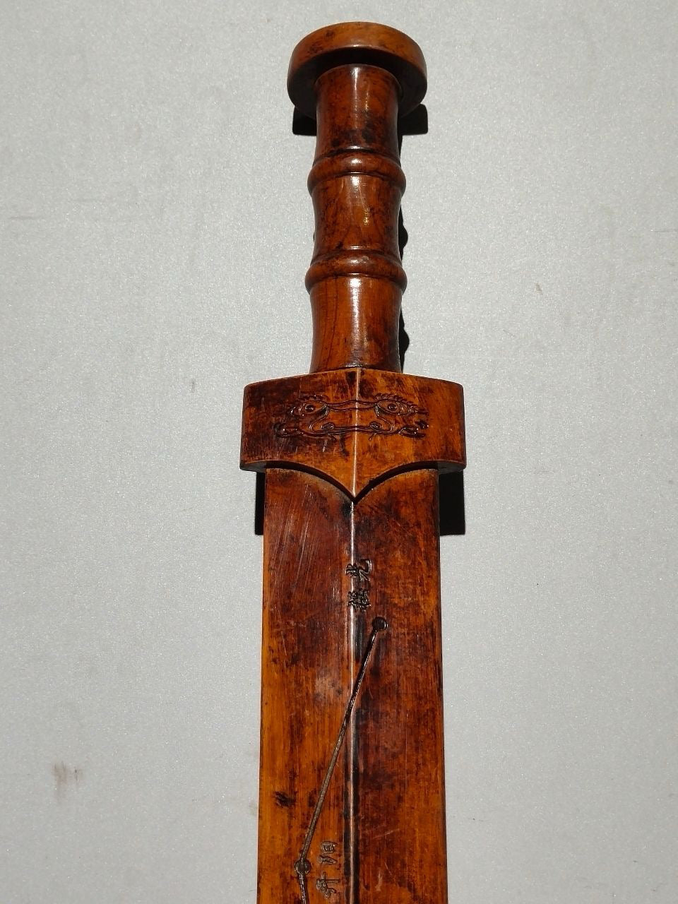 A solid wood carved sword