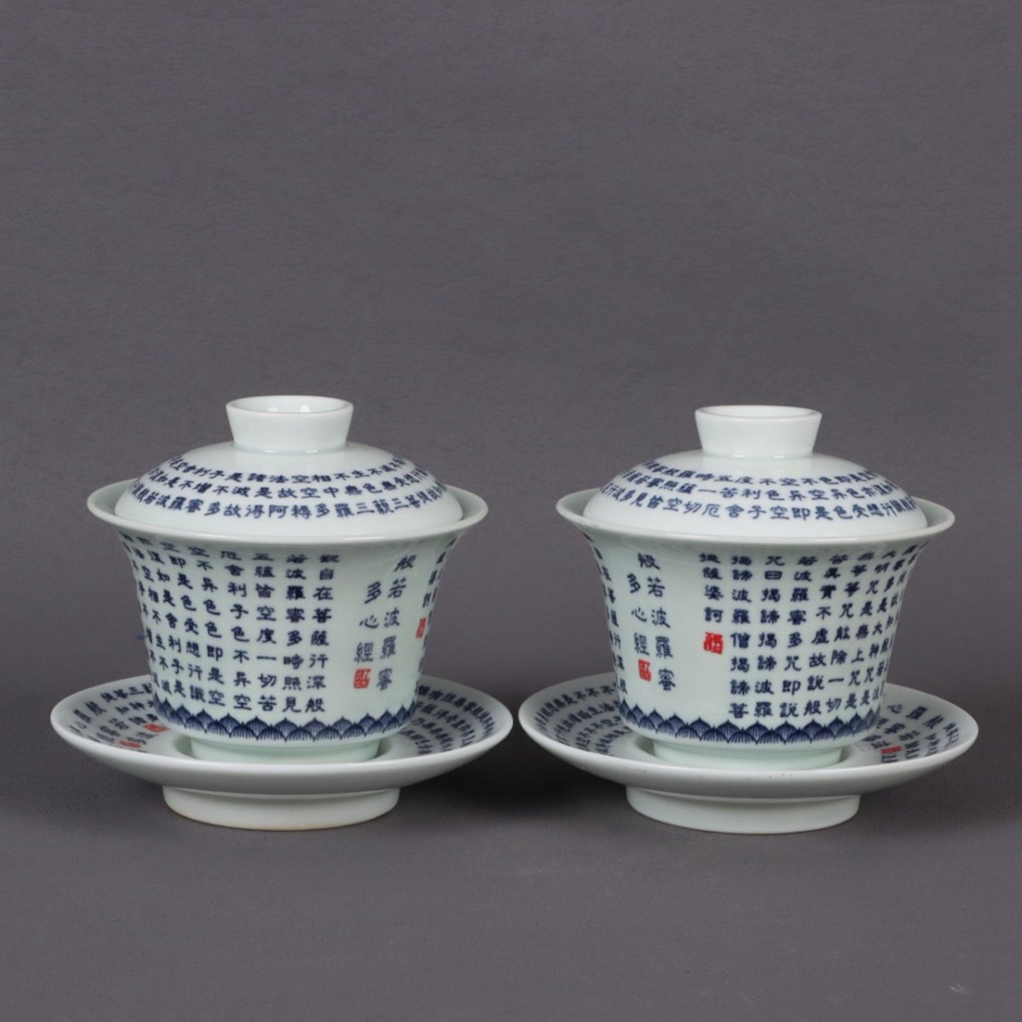 A pair of ceramic blue and white glazed covered bowls