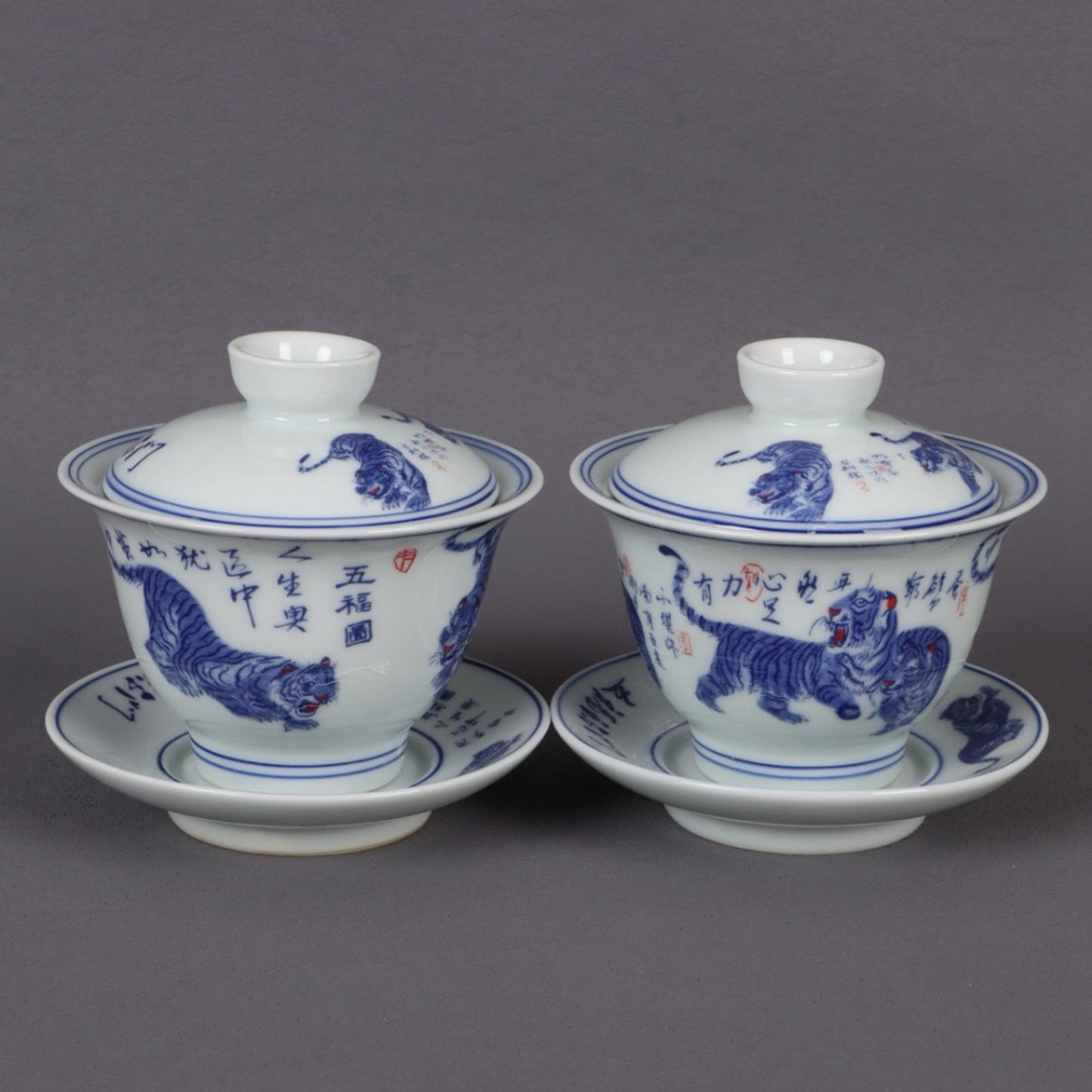 A pair of ceramic blue and white glazed covered bowls