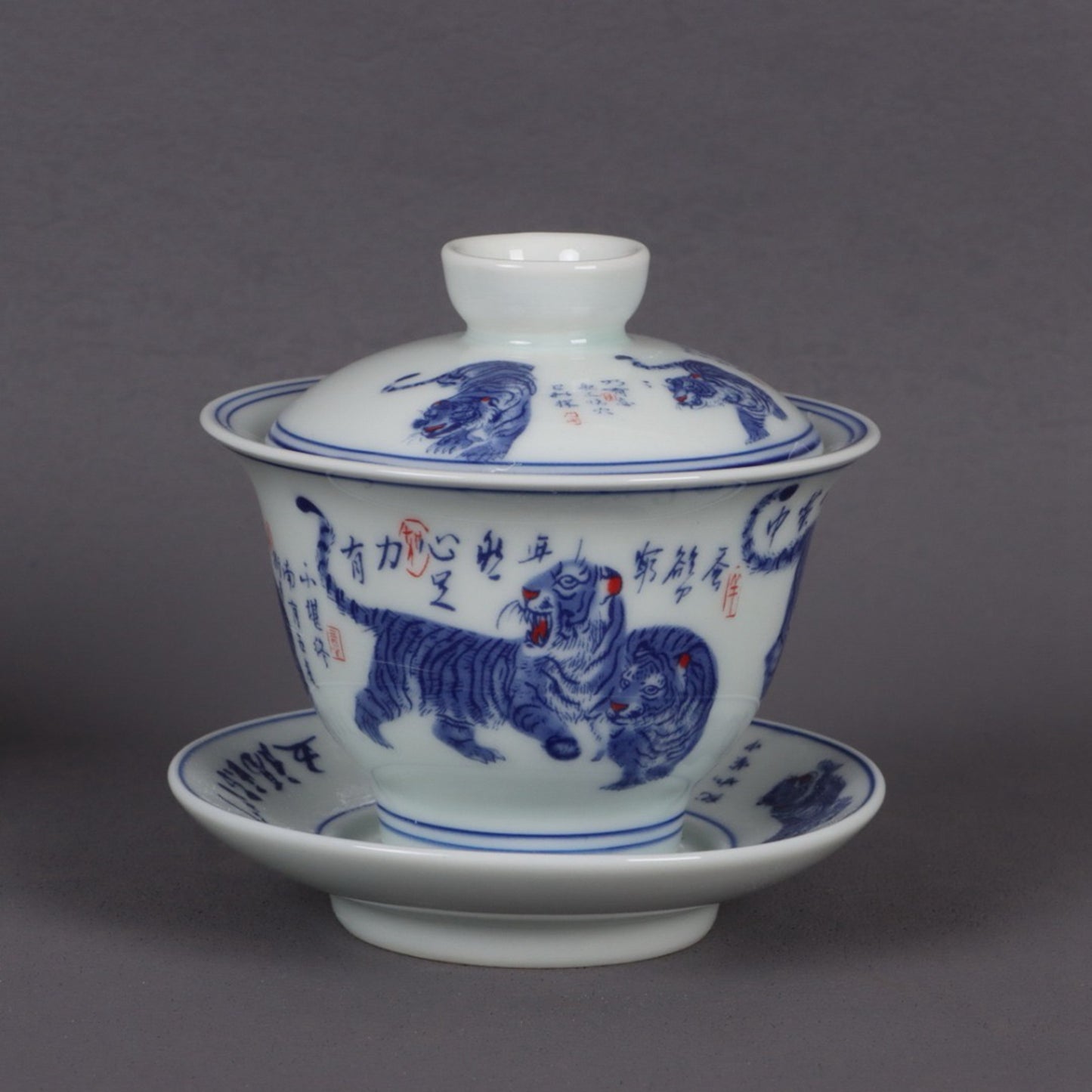 A pair of ceramic blue and white glazed covered bowls