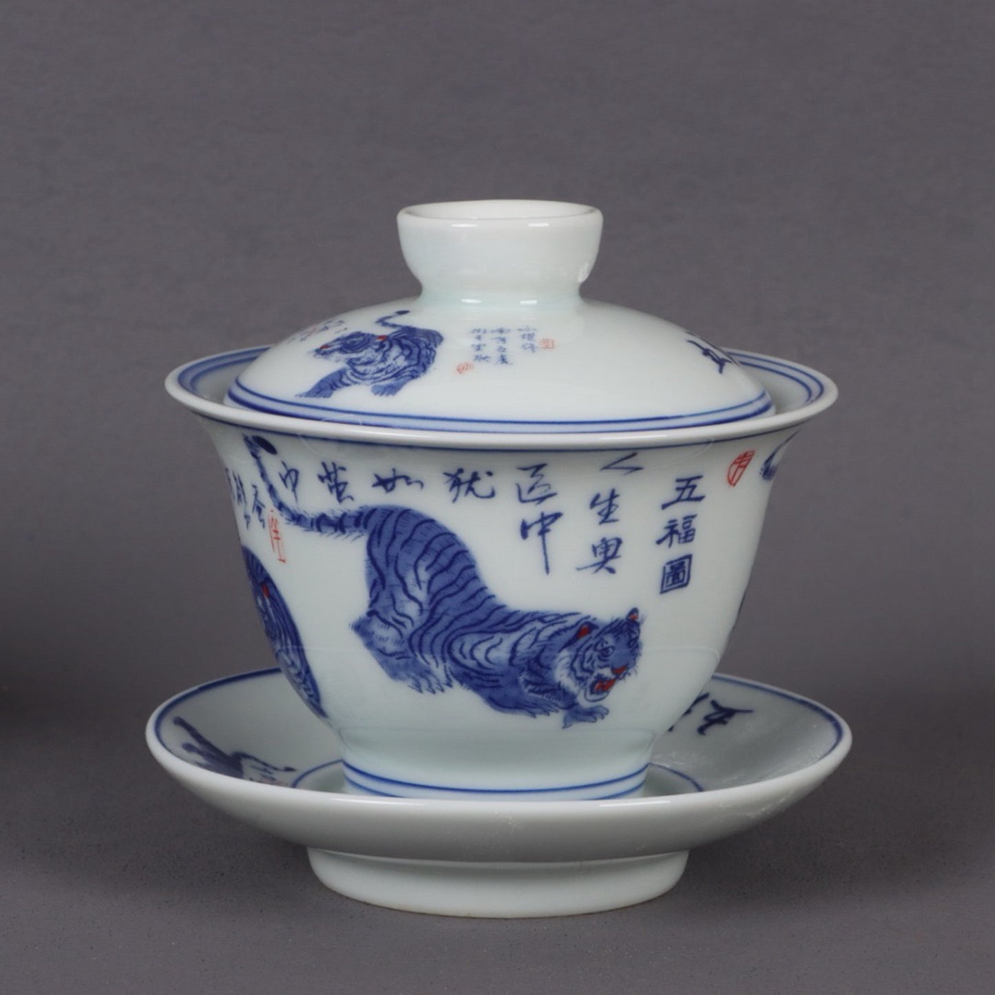 A pair of ceramic blue and white glazed covered bowls