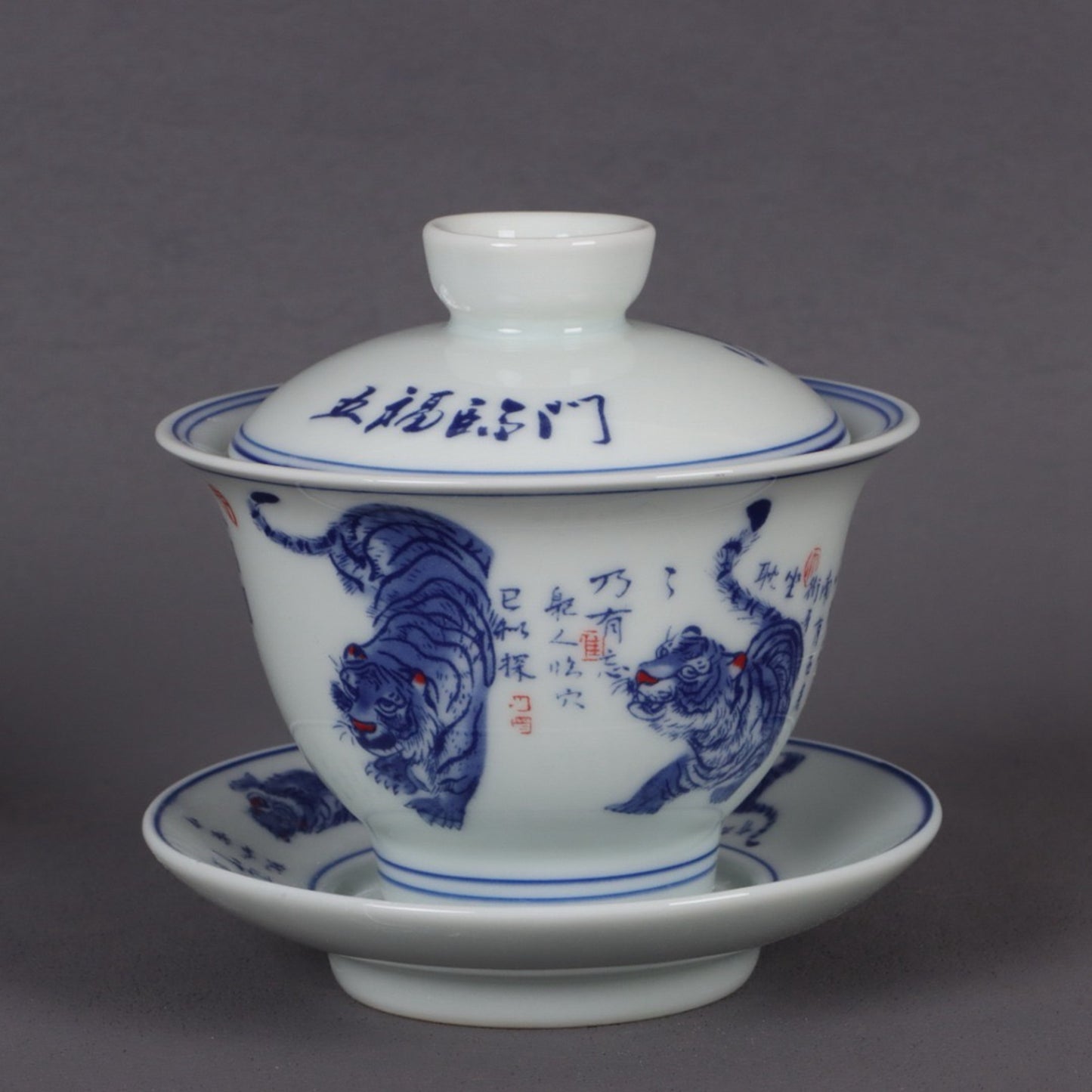 A pair of ceramic blue and white glazed covered bowls