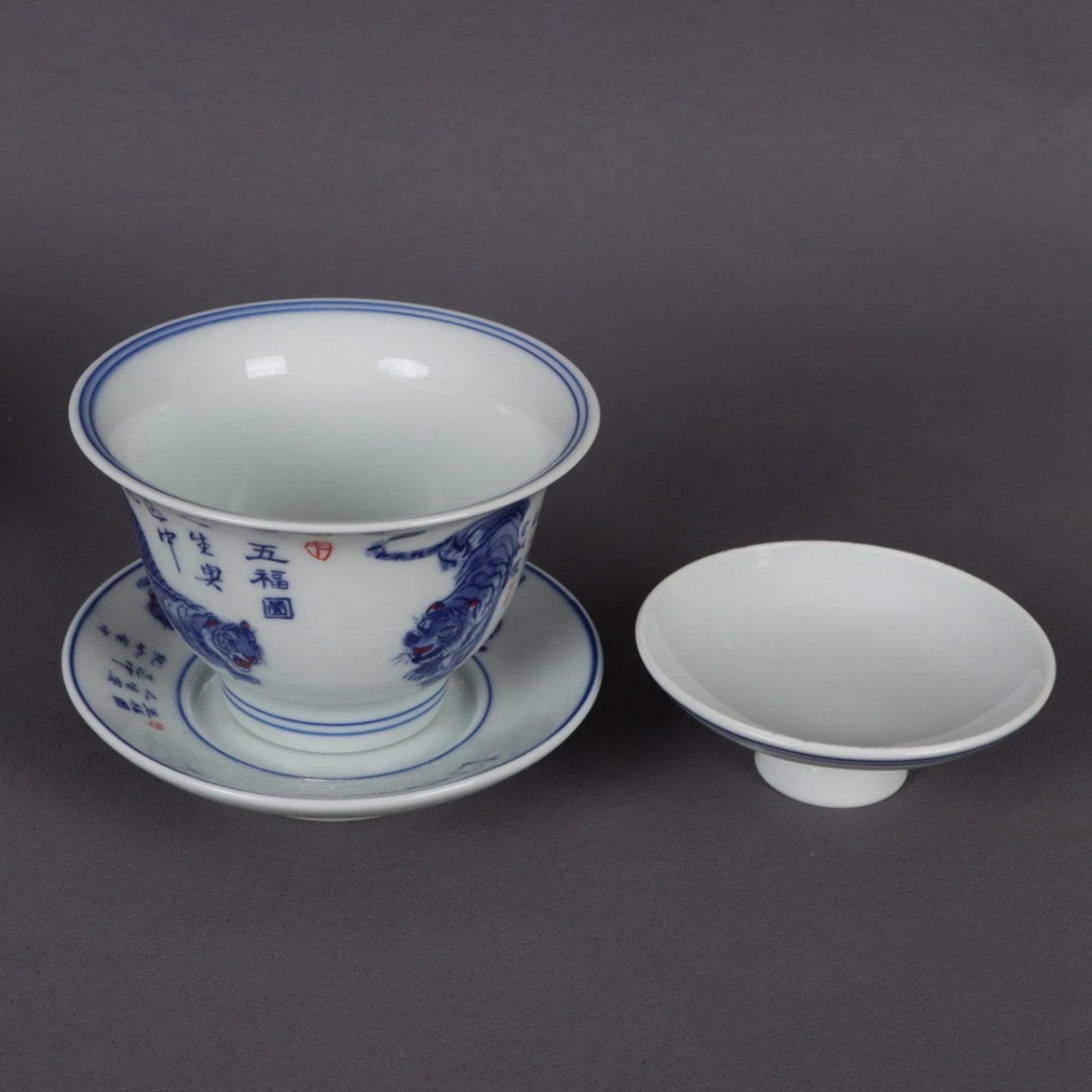 A pair of ceramic blue and white glazed covered bowls