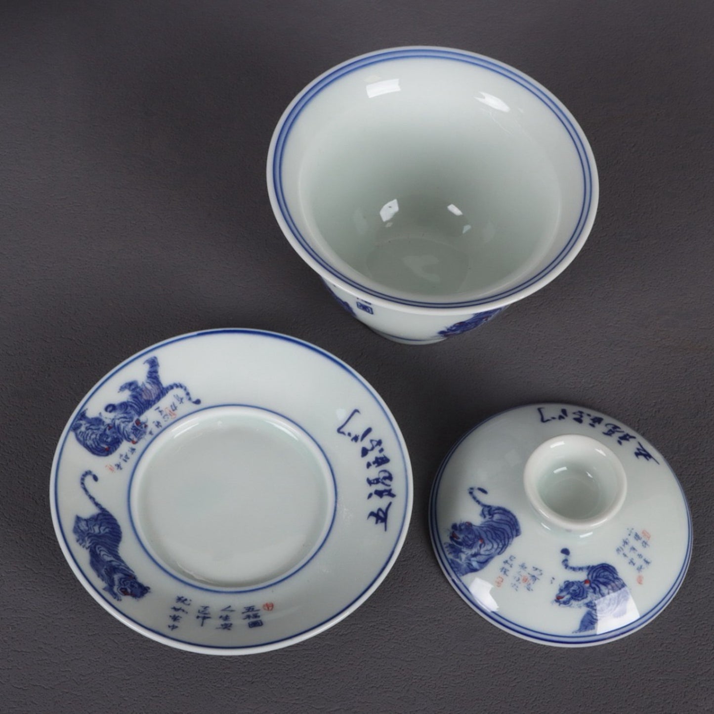 A pair of ceramic blue and white glazed covered bowls