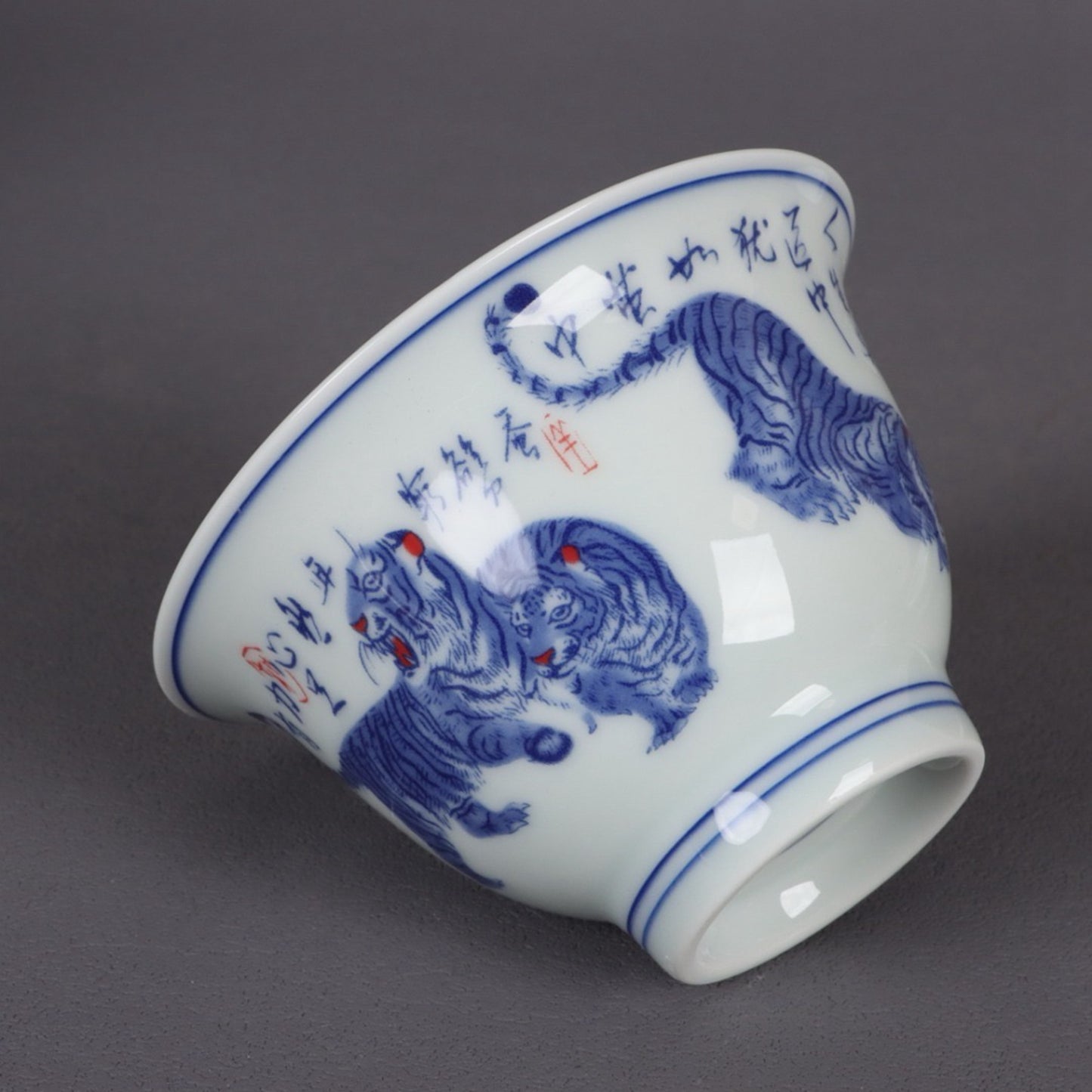 A pair of ceramic blue and white glazed covered bowls