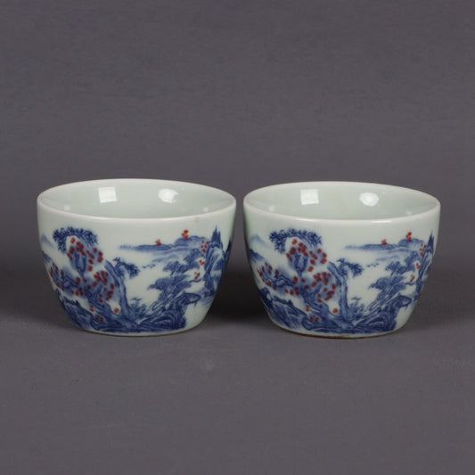 A pair of ceramic blue and white glazed flat bottomed cups