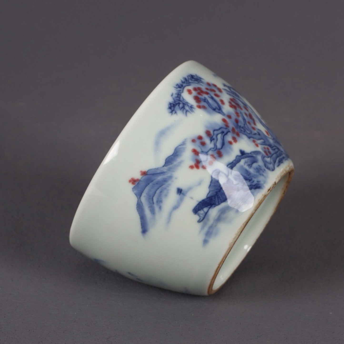 A pair of ceramic blue and white glazed flat bottomed cups