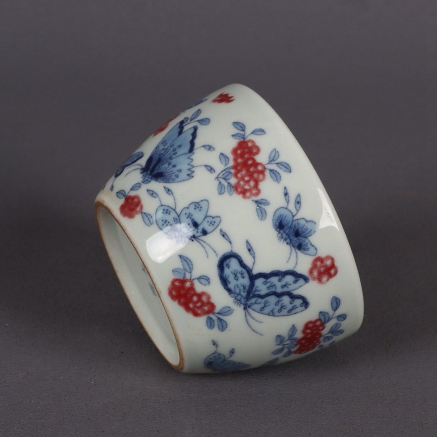 A pair of ceramic blue and white glazed flat bottomed cups