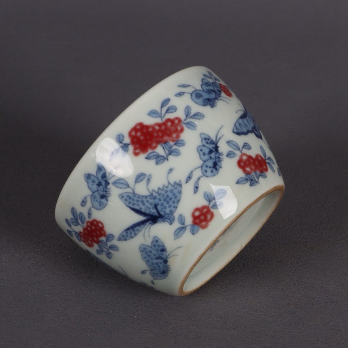 A pair of ceramic blue and white glazed flat bottomed cups