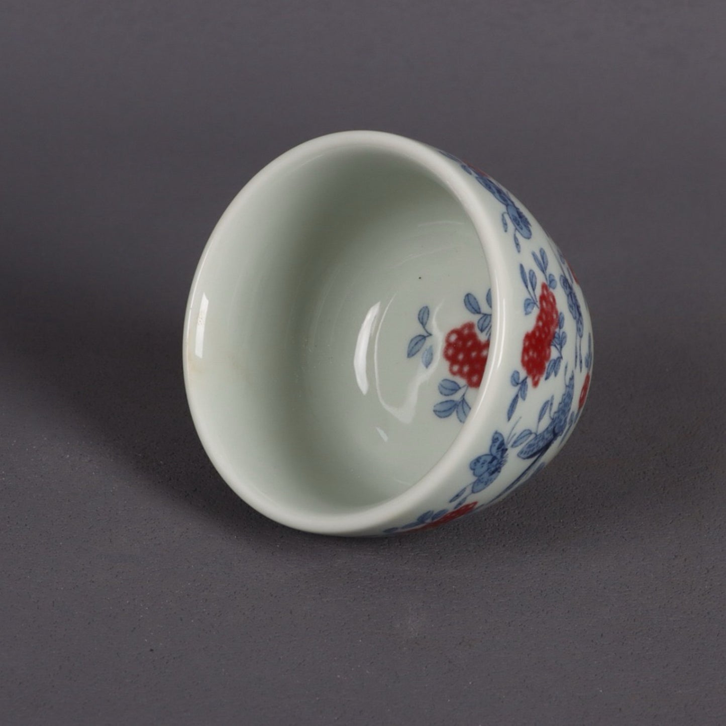 A pair of ceramic blue and white glazed flat bottomed cups